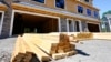 FILE - Lumber sits in stacks at a construction site in Middleton, Massachusetts, June 24, 2021. President Donald Trump on Saturday ordered a new trade investigation that could heap more tariffs on imported lumber.