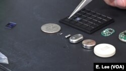 The implants — pictured to the right of the U.S. quarter — use nanochannels to release medication at the molecular level.