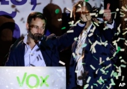 Santiago Abascal, leader of far right party Vox, gestures supporters gathered outside the party headquarters following the general election in Madrid, April 28, 2019.