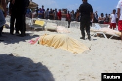 The body of a tourist shot dead by a gunman lies near a beachside hotel in Sousse, Tunisia, June 26, 2015.