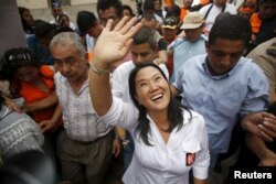 FILE - Peruvian presidential candidate Keiko Fujimori greets supporters at Cerro San Cosme on the outskirts of Lima, Jan. 8, 2016.