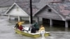 FILE - St. Bernard Parish Deputy Sheriff Jerry Reyes uses his boat to rescue residents after Hurricane Katrina hit the area causing flooding in their New Orleans neighborhood, Aug. 29, 2005.
