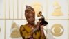 FILE - Angelique Kidjo, seen in this Feb. 15, 2016 photo with award for best world music album for "Sings" at the 58th annual Grammy Awards, has won a human rights award, along with three African youth activist movements, for their work defending freedom of expression and peaceful protest.