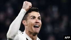 Juventus' Portuguese forward Cristiano Ronaldo celebrates after scoring 2-0 during the UEFA Champions League round of 16 second-leg football match Juventus vs Atletico Madrid on March 12, 2019 at the Juventus stadium in Turin. (Photo by Marco BERTORELLO /
