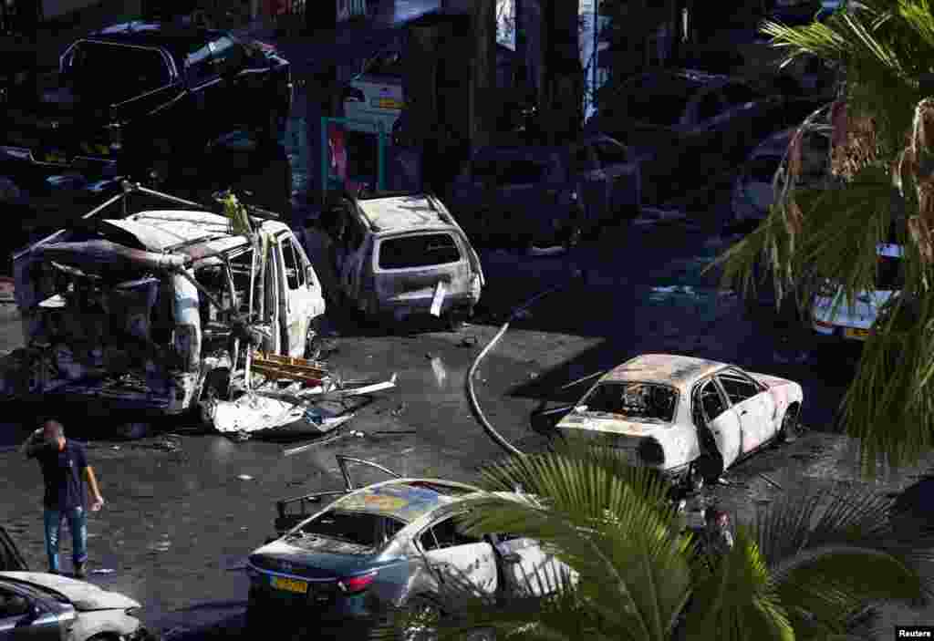 A man surveys the damaged at a petrol station that was hit by a rocket in the southern Israeli city of Ashdod, July 11, 2014.