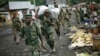 FILE - In this Nov. 30, 2012 file photo, M23 rebels withdraw from the Masisi and Sake areas in the eastern Congo town of Sake, some 27 kms west of Goma, Congo. 