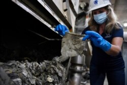 FILE - Lyn Riggins, WSSC Water spokesperson, holds up a wipe that was collected along with other debris at a pumping station in Washington.