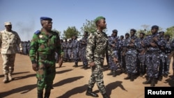 Kepala Staf Tentara Pantai Gading Soumaila Bakayoko (kiri) dan Kepala Staf Tentara Mali Ibrahima Dahirou Dembele (tengah) menginspeksi barisan tentara gabungan mereka di pangkalan militer di bandara Bamako, Mali, January 16, 2013. (REUTERS/Joe Penney)