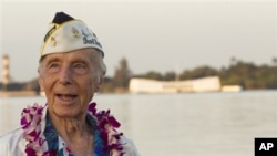 With the USS Arizona memorial in the background, Pearl Harbor survivor Richard Laubert, of Phoenix, Oregon, attends the 69th anniversary ceremony marking the attack on Pearl Harbor, 7 Dec 2010, in Pearl Harbor, Hawaii