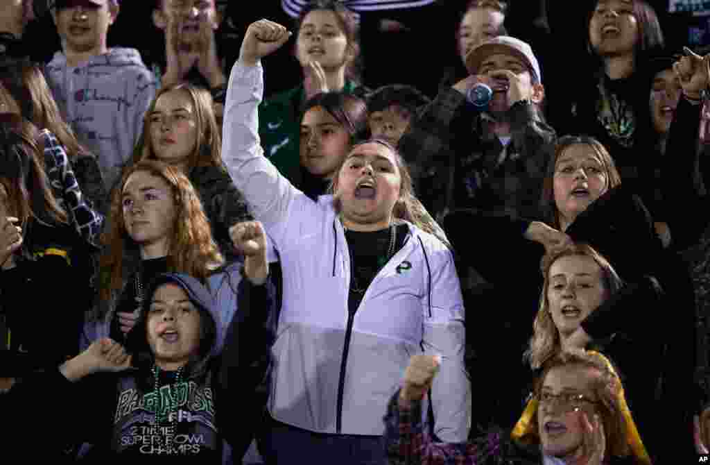 Paradise High School students cheer for their school&#39;s football team during their CIF Northern California Section Division III playoff game in Paradise, Calif., Nov. 15, 2019. 