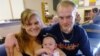 New parents Garrett Goudeseune, 25, Laura Fritz, 27, left, with their daughter Adalade Goudeseune, are at the Jefferson Action Center, an assistance center in the Denver. The couple has struggled to find work, now relying on government assistance to cover food and $650 rent for their family, July 16, 2012.