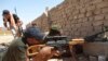FILE - Members of Iraqi security forces are seen during a fight with Islamic State (IS) militants on the outskirts of Ramadi, Sept. 14, 2014. 