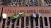 FILE - A rose lies at the Gleis 17 (Platform 17) memorial, a platform at Berlin-Grunewald train station from which Jewish citizens were deported by train to the Nazi concentration camps between 1941 and 1945, in Berlin, Germany, Jan. 27, 2021. 