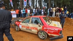 People gather around a car that crashed into the spectators during the Fox Hill Supercross, a motor racing event organized by Sri Lanka's army, in Diyatalawa, Sri Lanka, April 21, 2024. 