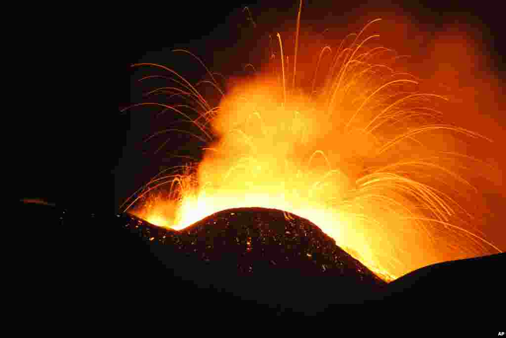 Lava spews from the Southeast Crater of Mt. Etna in Sicily, southern Italy.