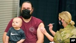A man receives a COVID-19 vaccine, March 25, 2021, in Spanish Fork, Utah.