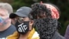 Protesters wear masks to help prevent the spread of the coronavirus, June 5, 2020, in Tacoma, Wash.