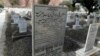 FILE - The word "Muslim" has been painted over by vigilantes, on the tombstone of Pakistani scientist Abdus Salam, a member of the Ahmadi community and Pakistan's only Nobel laureate, in the Ahmadi graveyard in the town of Rabwa, Dec. 9, 2013. A recent assassination victim in Pakistan was a relative of Salam.