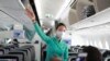 A flight attendant gives instructions to passengers on a plane in Ho Chi Minh City, Vietnam, March 16, 2020. 
