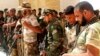 Newly-arrived Iraqi Shi’ite militiamen check their weapons in the predominately Sunni city of Nukhayb, southwest Iraq, May 21, 2015.