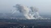 In this picture taken from the northern Syrian village of Ariha, smoke billows from the site of clashes and mutual shelling on the outskirts of the city of Saraqib in Syria's Aleppo province on Nov. 28, 2024. 