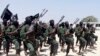 FILE - Hundreds of newly trained al-Shabab fighters perform military exercises in the Lafofe area 18 km south of Mogadishu, Somalia, Feb. 17, 2017. 