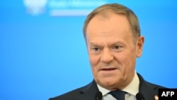 Poland's Prime Minister Donald Tusk addresses a press conference with his British counterpart after talks at the Prime Minister's Office building in Warsaw, Poland, on January 17, 2025. (Photo by Sergei GAPON / AFP)