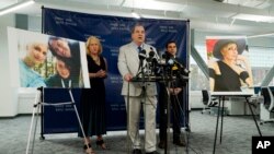 Randi McGinn, from left, Brian Panish and Jesse Creed, attorneys for the family of cinematographer Halyna Hutchins, take part in a news conference alongside portraits of Hutchins and her family, Feb. 15, 2022, in Los Angeles.
