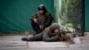 Ukrainian soldiers take positions in downtown Kyiv, Ukraine, Friday, Feb. 25, 2022. 