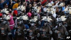 People watch the city's first Day of the Dead parade on Reforma Avenue in Mexico City, Oct. 29, 2016. 