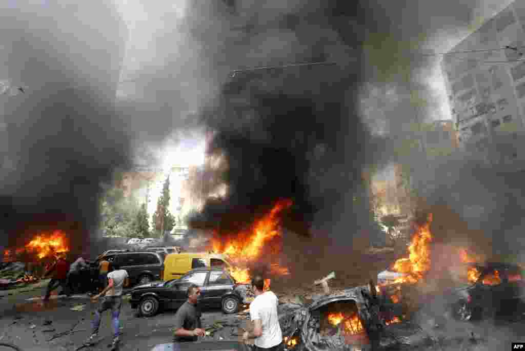 Civilians gather at the site of an explosion in Beirut&#39;s southern suburb neighbourhood of Bir al-Abed. A car bomb rocked the district, stronghold of Lebanon&#39;s Shiite Hezbollah movement, wounding 15 people, television reports and a military source said.