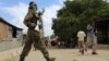 FILE - A Somali soldier patrols a street following a suicide car bomb and gun attack in Afgoye, Somalia, Oct. 19, 2016.