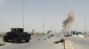 Smoke rises from a bomb attack in clashes between Iraqi security forces and Islamic State militants on the outskirts of Ramadi, April 9, 2015. 