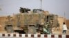 FILE - A Turkish soldier stands near his armored vehicle on a highway near the northern Syrian town of Ain Issa in the countryside of the Raqqa region, Nov. 26, 2019, as Turkey-backed forces were deploying reinforcements around town.