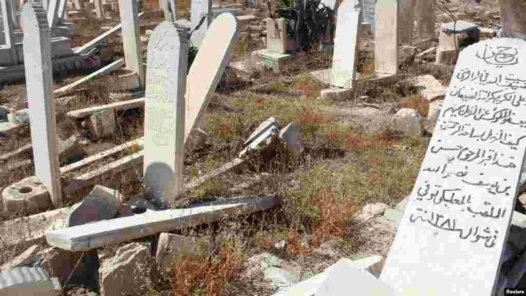 Damaged graves are pictured at a cemetery in Duma neighborhood in Damascus, Oct. 1, 2013.