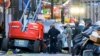 EDITORS NOTE: Graphic content / Police investigators surround the white Ford F-150 pickup truck that crashed into a work lift after allegedly driving into a crowd of New Year's revelers in the French Quarter of New Orleans, Louisiana, on January 1, 2025.