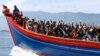 Ethnic Rohingya refugees from Myanmar wave as they are transported by a wooden boat to a temporary shelter in Krueng Raya in Aceh Besar, Indonesia, April 8, 2013.