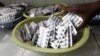 FILE - Ruth Munyao, a pharmacist, dispenses antiretroviral drugs at the Mater Hospital in Kenya's capital of Nairobi, Sept. 10, 2015. 