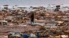 FILE - A boy carries a roofing sheet on the beach in the aftermath of Cyclone Chido, in Passamainty, Mayotte, Dec. 20, 2024. Residents of the French territory of Mayotte braced Saturday for a storm expected to bring strong winds and heavy rain