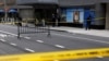 FILE - Police officers stand near the scene where UnitedHealthcare CEO Brian Thompson was gunned down in New York City, Dec. 4, 2024.