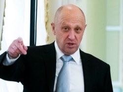 FILE - Yevgeny Prigozhin gestures during a meeting between Russian President Vladimir Putin and Turkish President Recep Tayyip Erdogan at the Konstantin palace outside St. Petersburg, Russia, August 9, 2016.