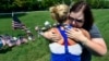 Sophia Ensley, left, comforts Barbie Branum by a makeshift memorial at the entrance to the Naval Operational Support Center and Marine Reserve Center in Chattanooga, Tennessee, July 18, 2015.