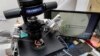 FILE - Lab staff use articulated hand controls to extract cells from embryos, shown on the monitor at right, that are then checked for viability at the Aspire Houston Fertility Institute in vitro fertilization lab in Houston, Texas, Feb. 27, 2024. 