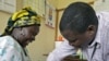Iren Salama (L) holds her baby Pendo as it is given an injection as part of a malaria vaccine trial at a clinic in the Kenya coastal town of Kilifi, November 23, 2010 (file photo)