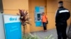 FILE - A man looks at the screen of an ATM of the failed Doral Bank in San Juan, Puerto Rico, February 27, 2015.