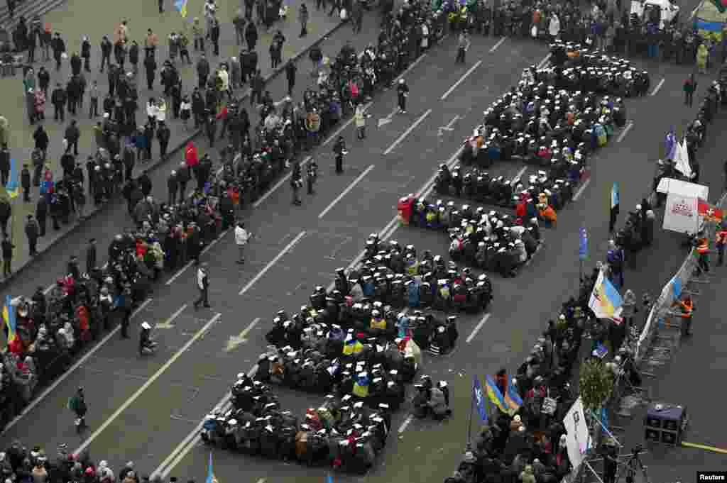 Pro-European integration protesters form the Ukrainian word for &quot;Lustration&quot; at Independence Square in Kyiv.