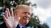 President Donald Trump smiles while speaking to reporters on the South Lawn of the White House in Washington, Nov. 8, 2019.