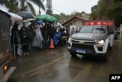 A police forensic truck leaves the Recanto Florido Condominium, where an airplane crashed with 62 people on board in Vinhedo, Sao Paulo, Brazil, on Aug. 10, 2024.
