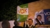 Members of Spain's far-right party VOX put up a campaign poster, while main candidates for Spanish general elections debate during a live televised debate ahead of general elections in Madrid, outside a polling station in Ronda, Spain April 22, 2019.