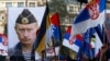 FILE - A supporter of Serbian ultranationalist leader Vojislav Seselj holds a picture of Russian President Vladimir Putin during a protest In Belgrade, Serbia. 